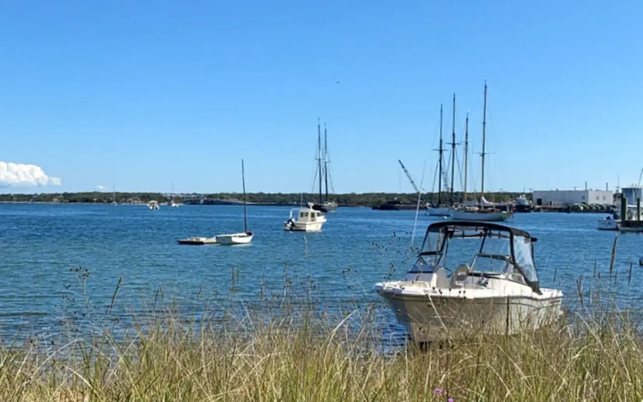 Small boats moored just off a beach in Vineyard Haven harbor