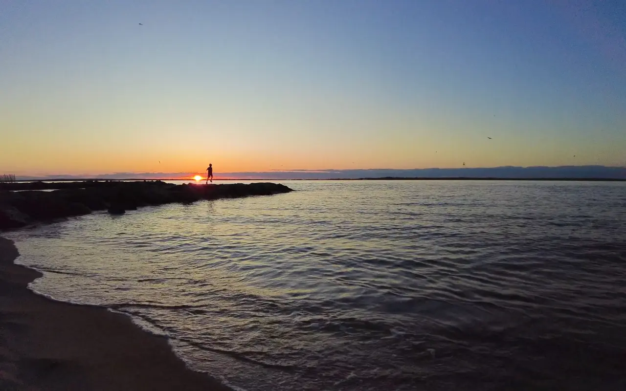 A lone figure on the jetty at sunset in Vineyard Haven