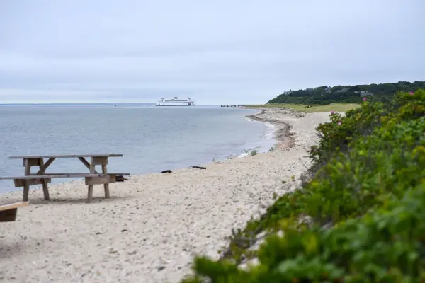 Picnic table on West Chop beach with ferry offshore
