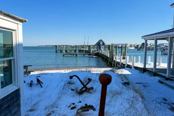 Snow-dusted harborfront yard with old anchors, Vineyard Haven