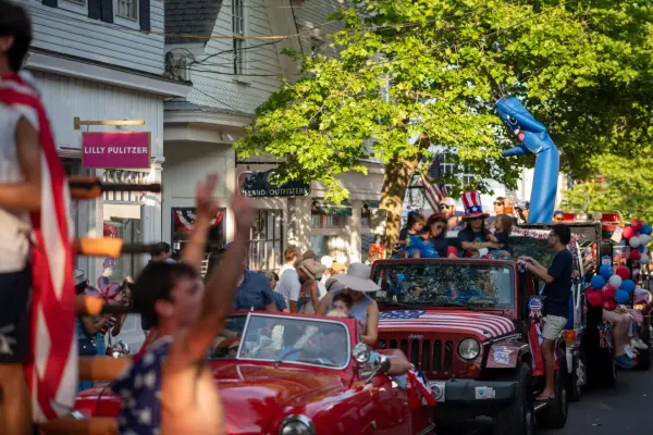 A flag-draped Jeep and cheering crowd during Edgartown's Fourth of July parade