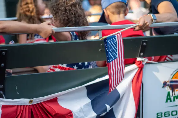 American flag and bunting on an open trolley float carrying children in the Edgartown Fourth of July parade