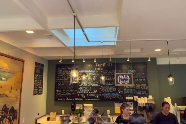 The chalkboard menu and counter inside 7a Foods, behind Alley's