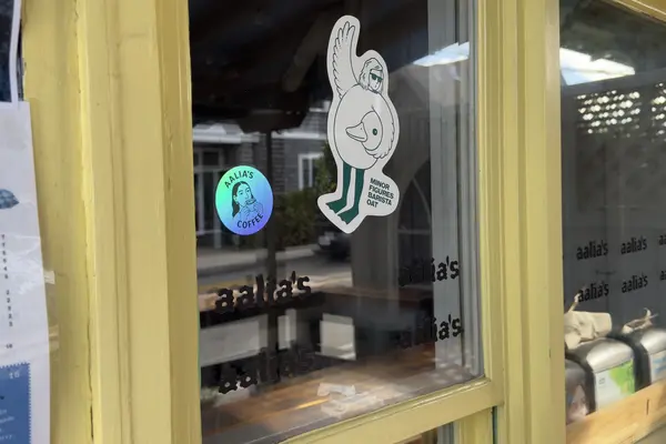 Aalia's window: stickers, the menu and a WVVY flyer