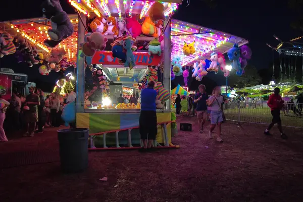 A game booth on the fair midway at night, 2025