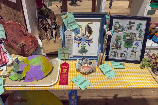 Sea glass artwork wearing second and third place ribbons