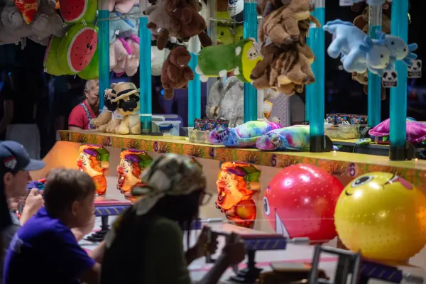 Water gun clowns and a wall of plush prizes waiting for winners