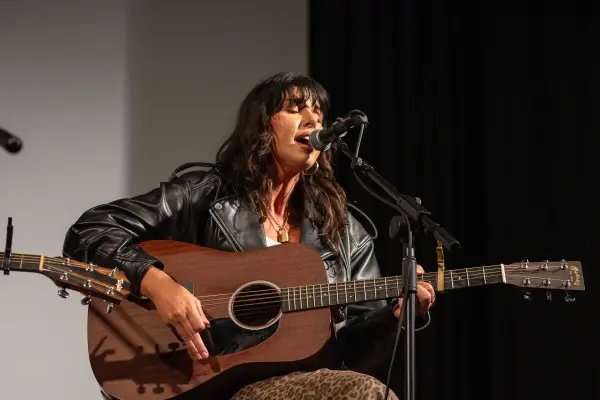 Alee, eyes closed, on a Martin acoustic