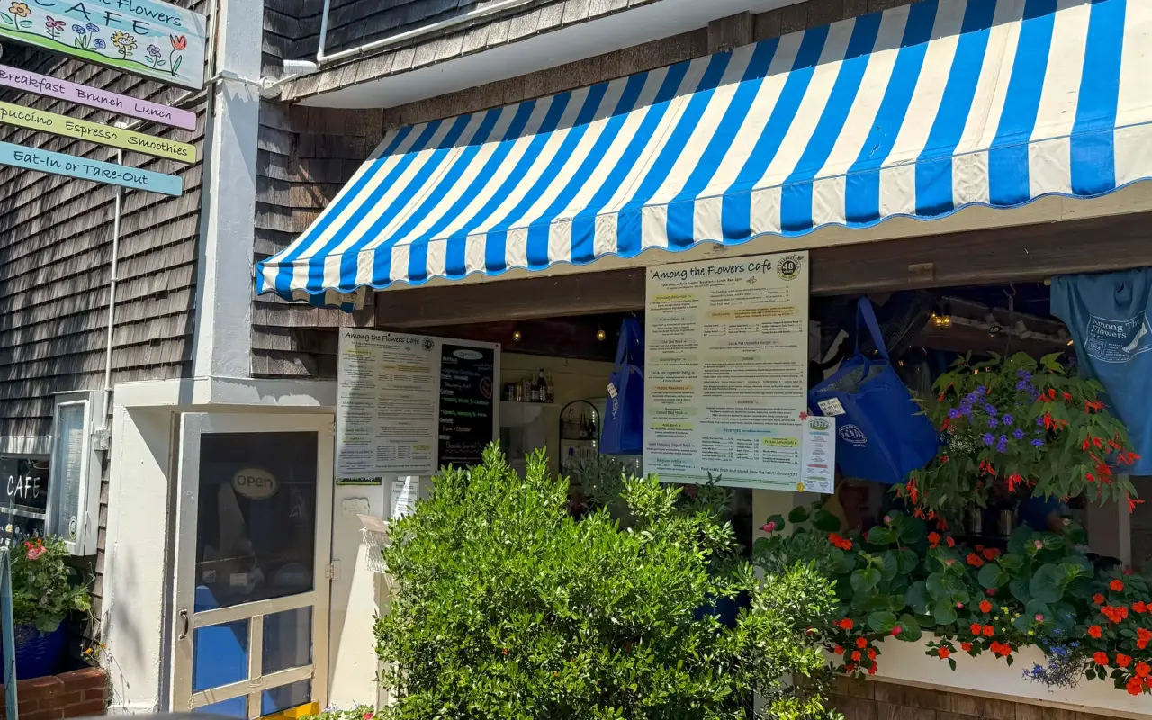 Among the Flowers Café entrance with striped awning in Edgartown