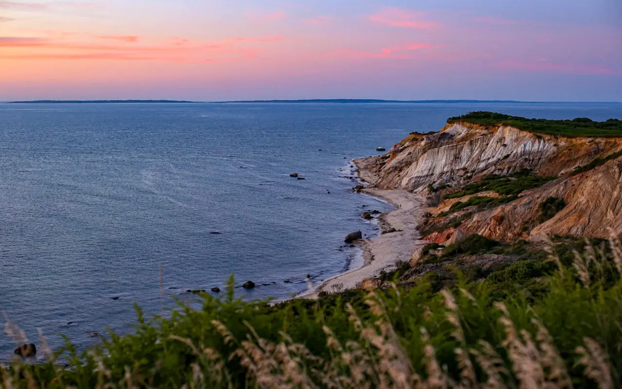 The Aquinnah cliffs curving above the beach at dusk