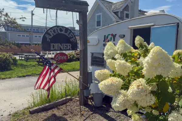 ArtCliff Diner sign with the Joy World coffee trailer parked alongside