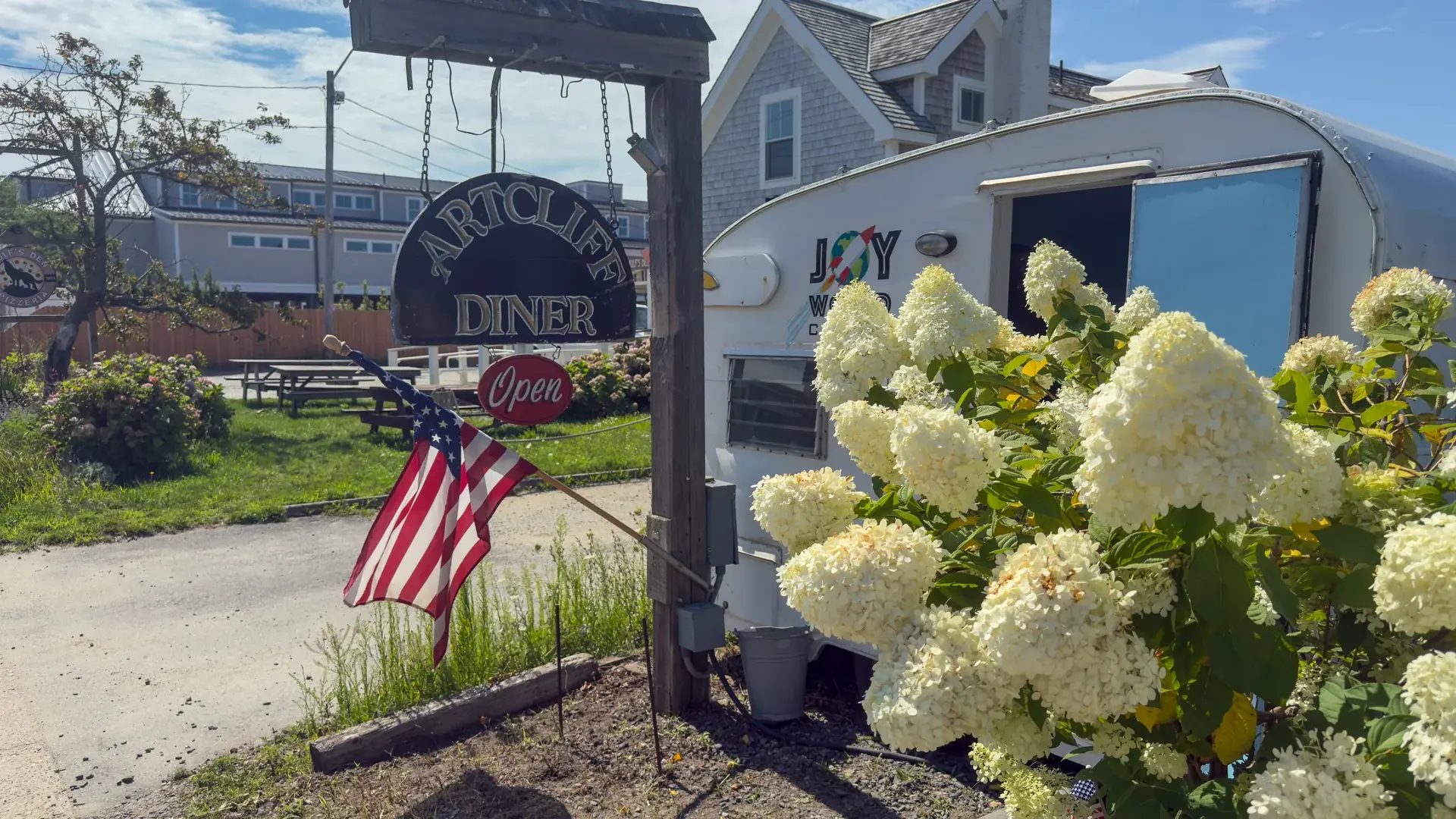 ArtCliff Diner sign with the Joy World coffee trailer parked alongside