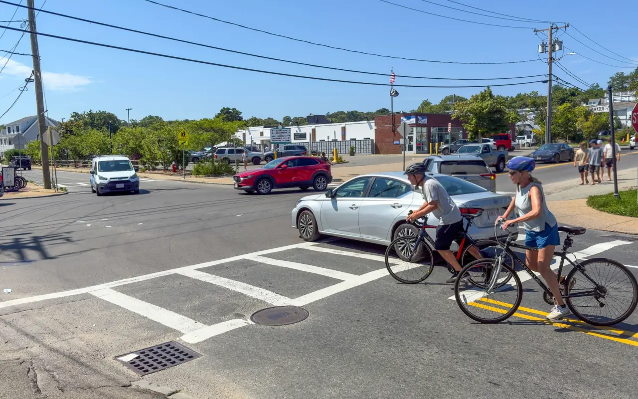 Cyclists crossing Five Corners in Vineyard Haven on a busy summer day