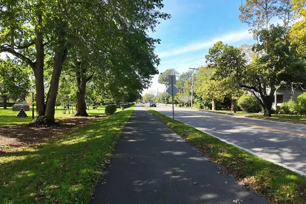 A bike path past a park with old cannons