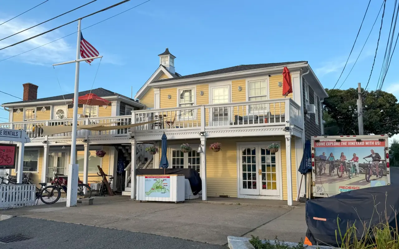 Yellow bike rental shop building in Oak Bluffs with flag and rental signage