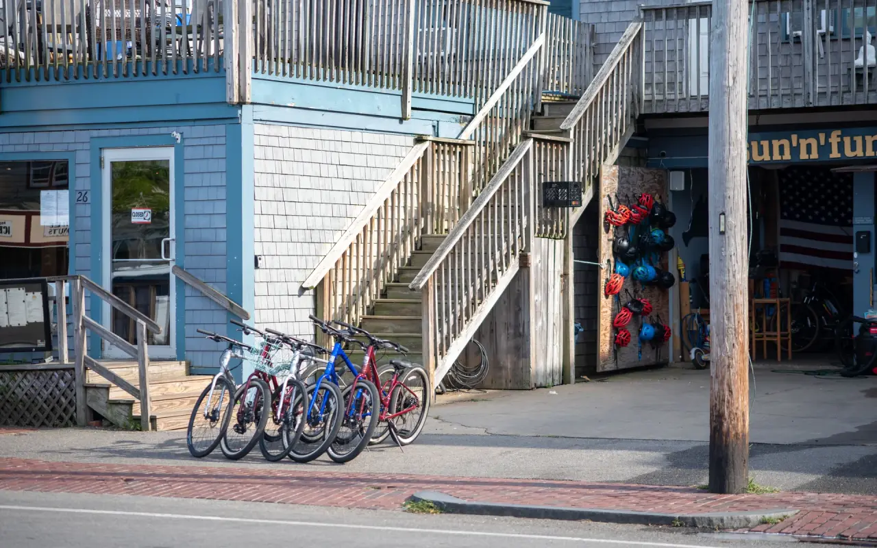 Rental bicycles lined up outside a blue shingled shop in Oak Bluffs on Martha's Vineyard