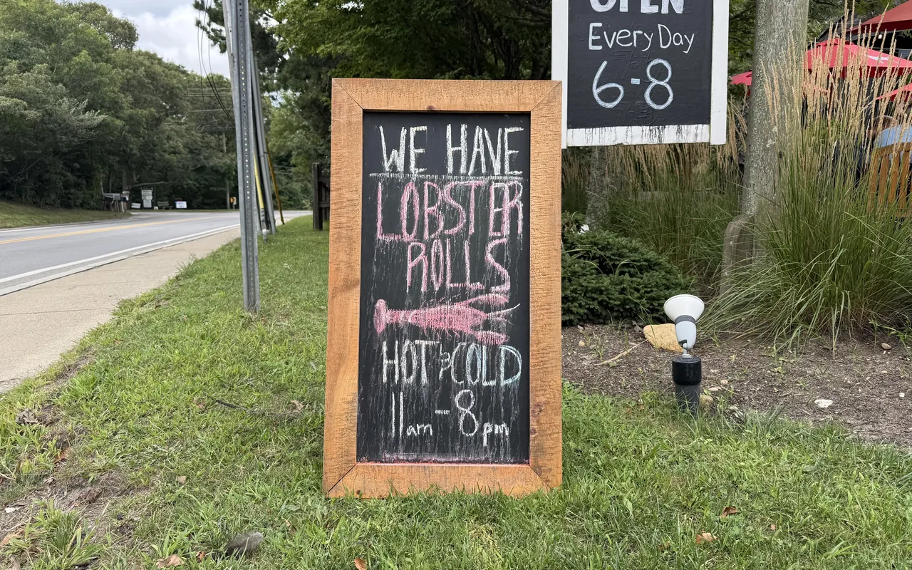 Chalkboard sign for hot and cold lobster rolls outside the Black Dog Bakery Cafe in Vineyard Haven