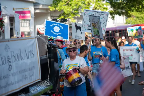 The Camp Jabberwocky troupe with drums and hand-painted local signs in the Edgartown Fourth of July parade