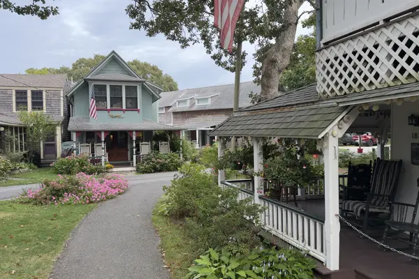 A Campground lane: the 1870 porch on the right, a blue cottage with pink trim ahead