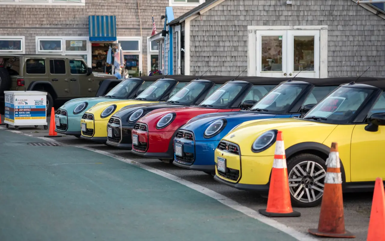 A row of colorful Mini rental cars parked in a lot in Oak Bluffs