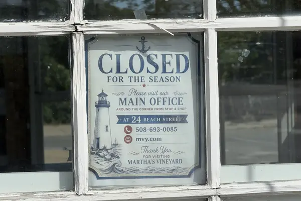 The Chamber's Closed for the Season sign pointing to 24 Beach Street