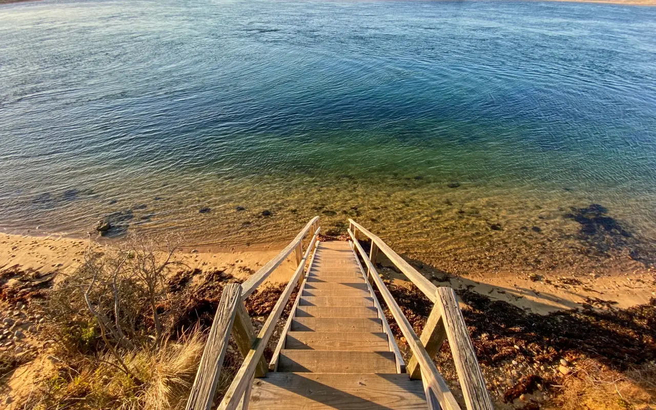 Wooden steps down to the clear water of a Chappaquiddick beach