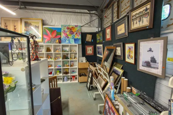 The art corner inside Chicken Alley: island paintings and prints, secondhand and priced to move.