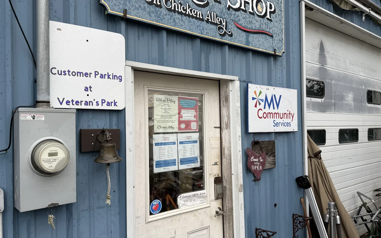 Front door of the Chicken Alley Thrift Shop in Vineyard Haven with hours posted