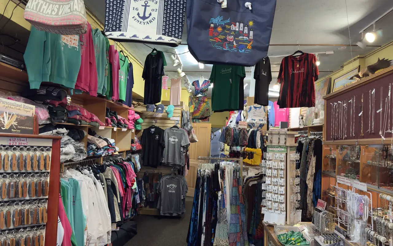Inside a Circuit Avenue souvenir shop in Oak Bluffs: hoodies, Inkwell tees, Martha's Vineyard tote bags, personalized knives and jewelry cases
