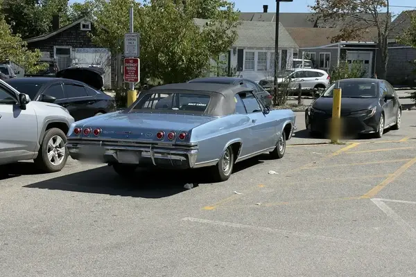 A mid-1960s Chevrolet Impala convertible in a Vineyard Haven lot