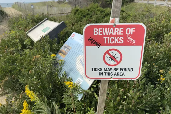 A dune path with the tick sign and the Army Corps panel on the old range