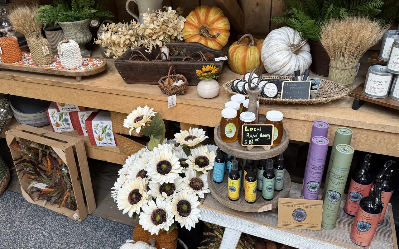 Jars of local raw honey and natural insect repellent bottles on a shelf at Second Nature at Eden garden centre in Vineyard Haven