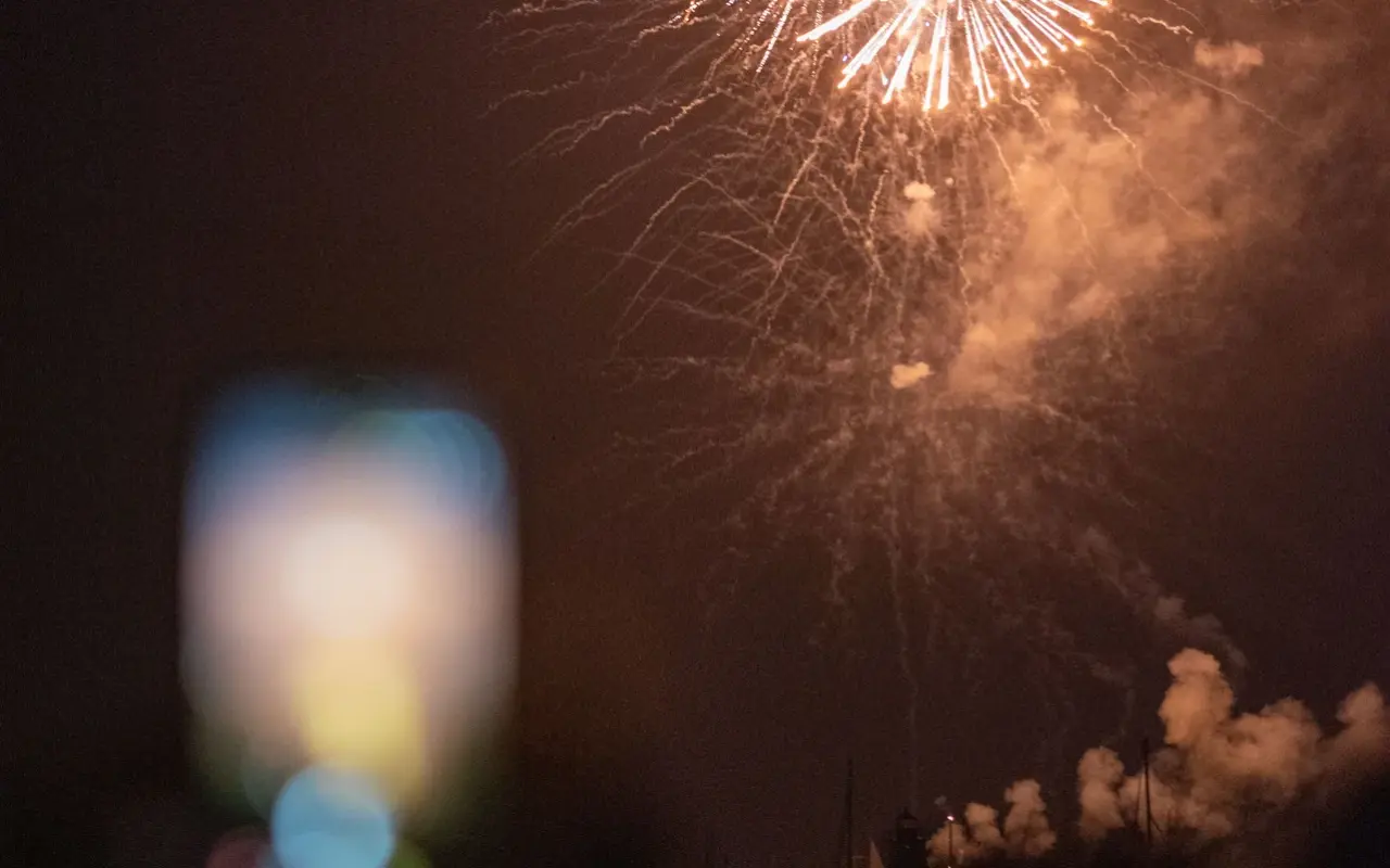 Crowds watching Fourth of July fireworks over Edgartown Harbor on Martha's Vineyard