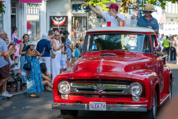 A classic red pickup rolling down Main Street in Edgartown's 2026 Fourth of July parade