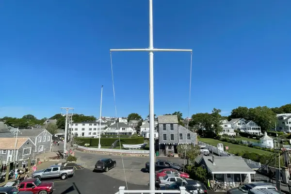 Flag mast at Memorial Wharf overlooking Edgartown rooftops