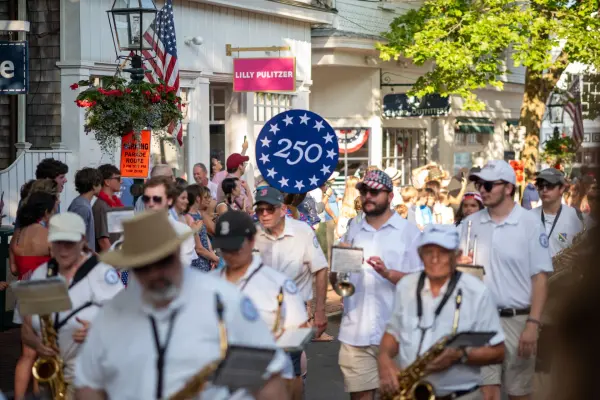 A marching band and the "America 250" banner in the 2026 Edgartown Fourth of July parade