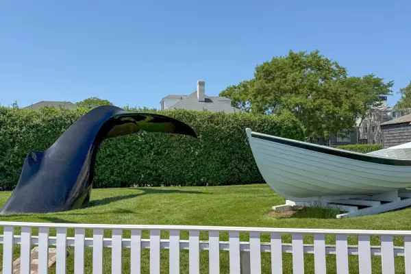Whale tail sculpture and whaleboat in Edgartown