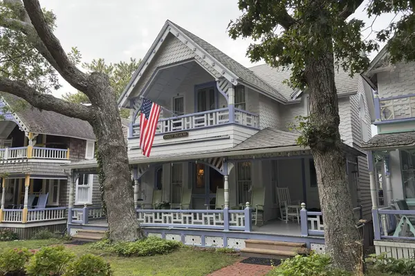 Family Treasure, number 29: lavender trim, a flag on the balcony, rockers on the porch