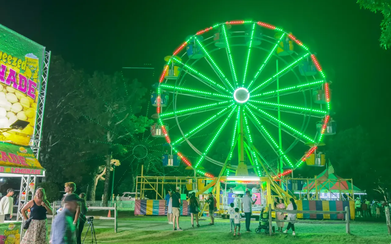 Ferris wheel lit green at night during the 2026 Agricultural Fair on Martha's Vineyard