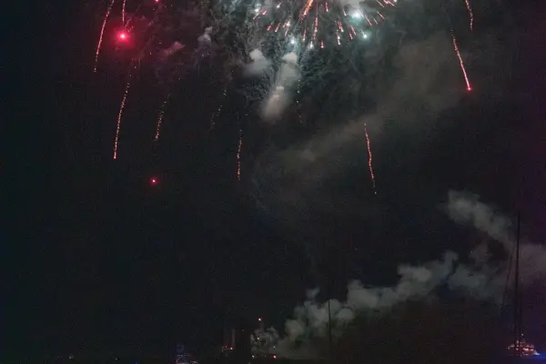 Fireworks over Edgartown Harbor with boats below