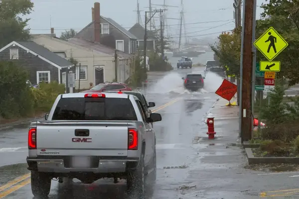 Detour Ahead: cars wading toward the harbor at Five Corners in the rain
