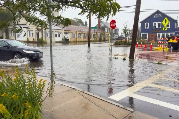 Water curb to curb at the Beach Road sign, sandbags by the Vineyard Grill