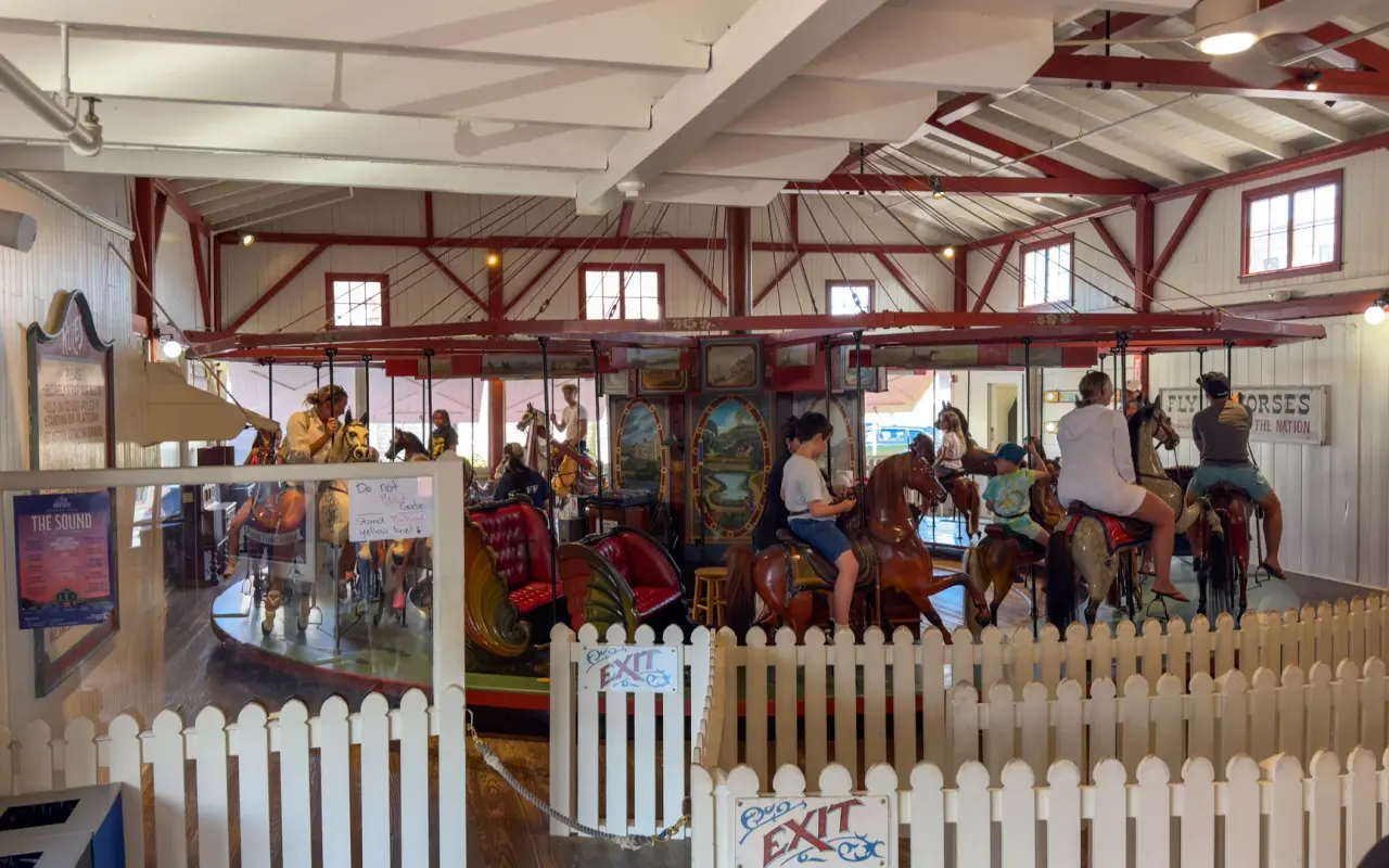 Riders on the Flying Horses Carousel inside its building in Oak Bluffs