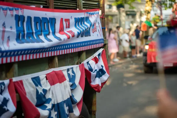 A "Happy 4th of July" banner on a bunting-draped parade float in Edgartown