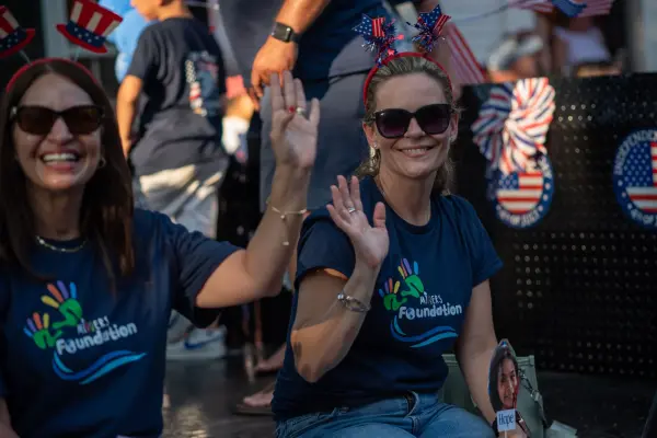 Foundation volunteers waving from a float in the Edgartown Fourth of July parade