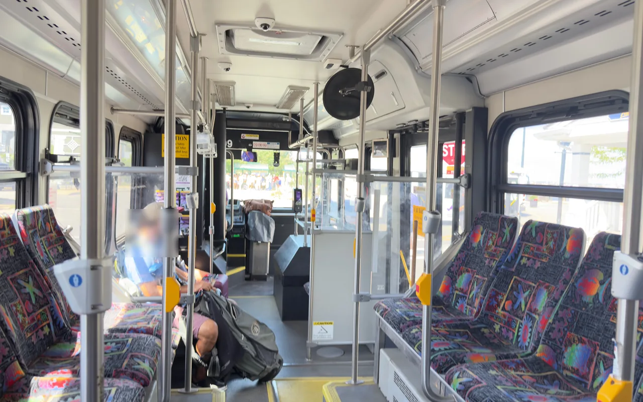 Inside a low-floor VTA bus with wide aisle and patterned seats