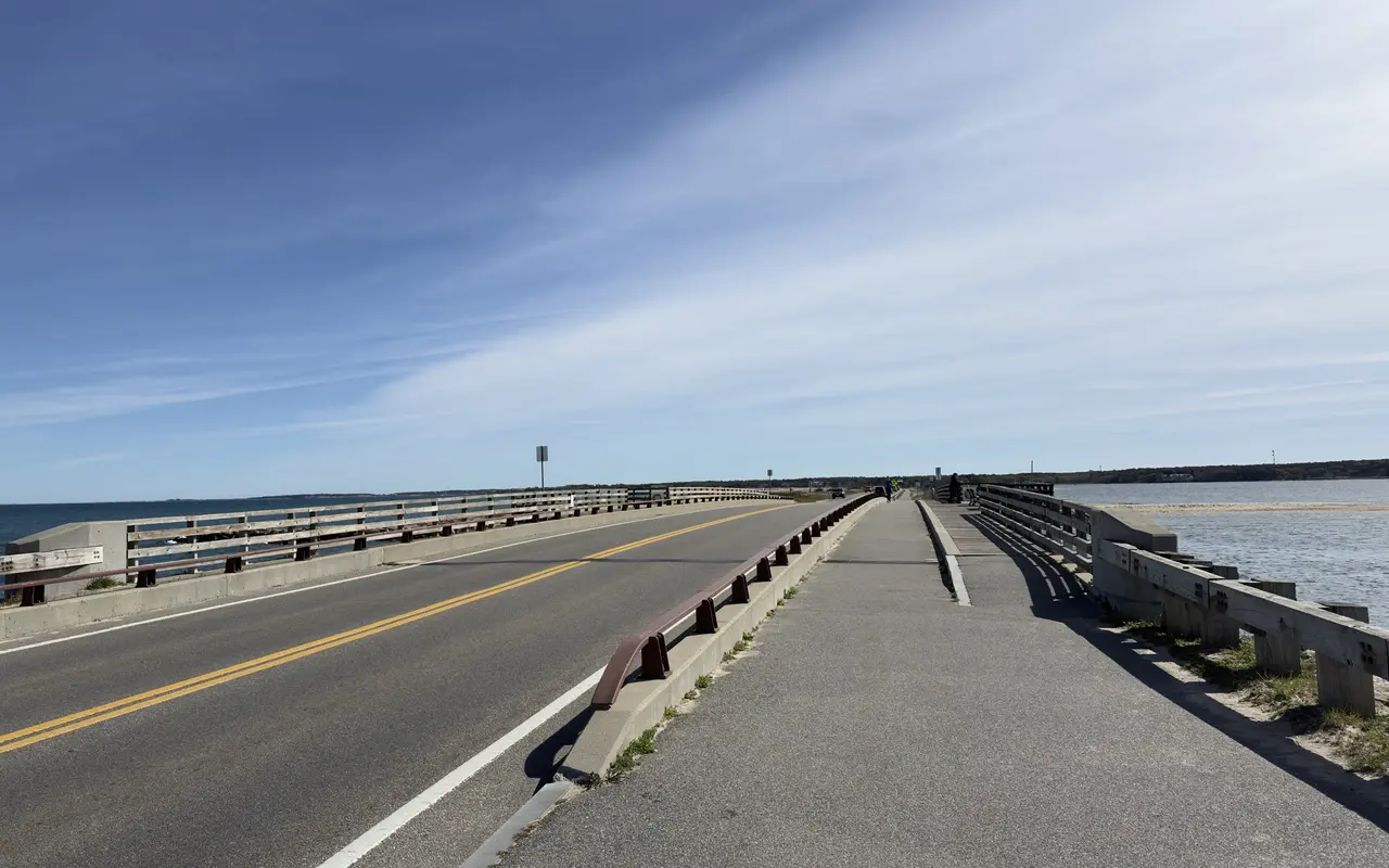 The American Legion Memorial Bridge on Beach Road with the road on the left and a paved bike path on the right, water on both sides