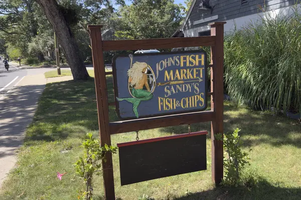 The mermaid sign for John's Fish Market and Sandy's Fish and Chips