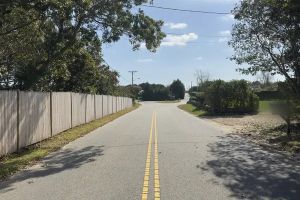 Edgartown Bay Road in Katama, with a long stockade fence