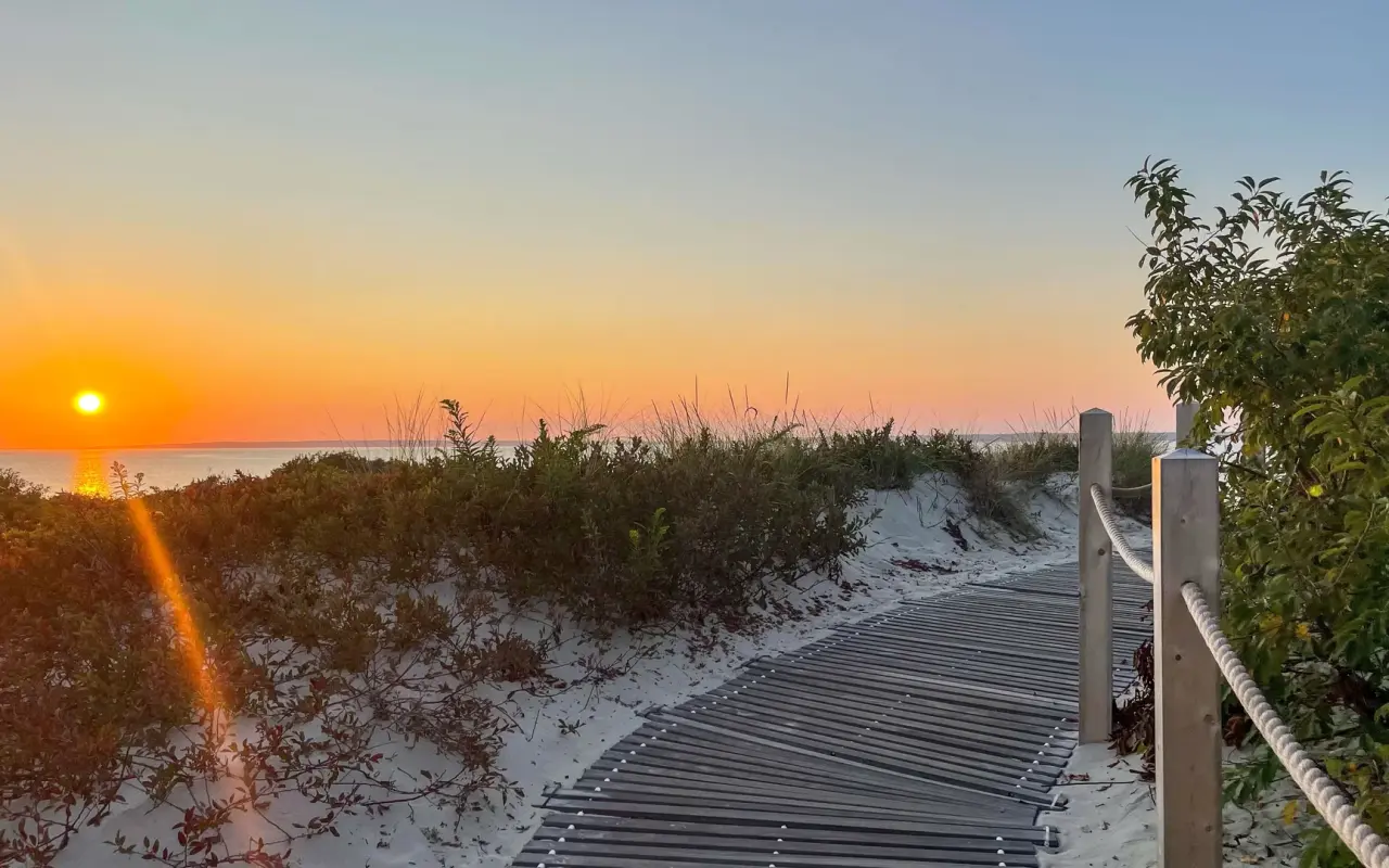 Sunset over the boardwalk at Lambert's Cove Beach in West Tisbury